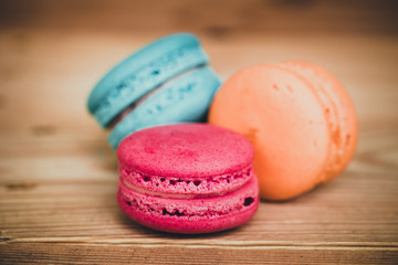 Macaron sweet dessert on wood background dark tone.