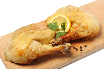 Grilled chicken with lemon on wood background