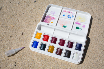 Watercolor box on beach background