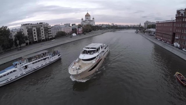 Aerial of moscow river navigation. Boat. Cathedral of Christ the Saviour. Moscow Kremlin. Golden dome churches, Moscow river. Car traffic at the walls of the Kremlin. Autumn panorama of Moscow city ce
