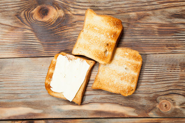 Breakfast, toast and coffee on a wooden background
