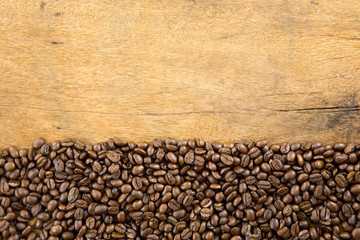 Coffee beans on wood background