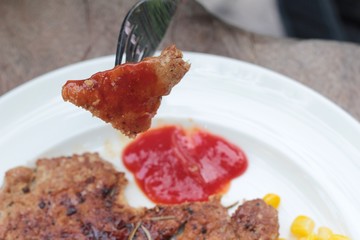 Grilled pork steak with  bread and ketchup.