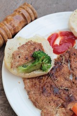 Grilled pork steak with  bread and ketchup.