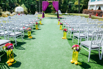Beautiful wedding archway with chairs on on each side