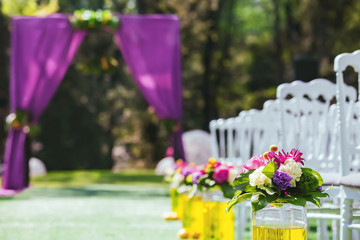 Beautiful wedding archway with chairs on on each side