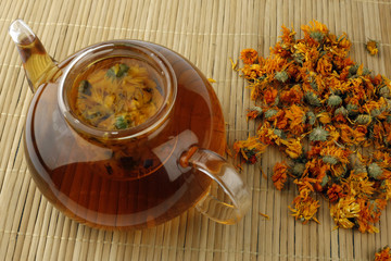 Tea from calendula flowers in glass teapot