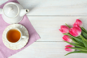 Tulips, a cup with tea and teapot