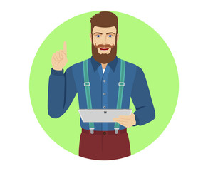 Hipster holding digital tablet PC and pointing up