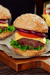 Cheeseburgers on wooden table with copy space