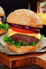 Cheeseburgers on wooden table with copy space