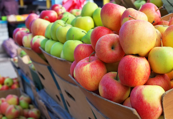Delicious colorful apples in the boxes on the market