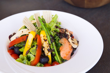 Salad with salmon on black table - 140603960