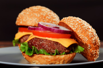 Cheeseburgers on wooden table with copy space