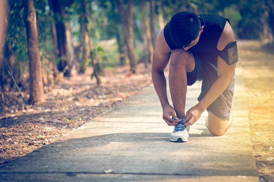 handsome man runners lace his shoes and prepare to jogging