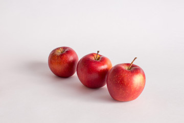 Red and green apples on a white background