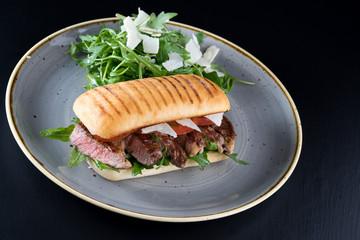 grilled steak medium fresh baked ciabatta sandwich beer