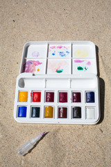 Watercolor box on beach background