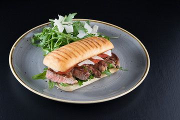 grilled steak medium fresh baked ciabatta sandwich beer