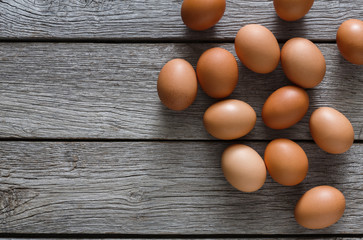 Brown and white organic eggs on wood background
