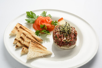 tasty Steak tartare (Raw beef) - classic steak tartare on white plate