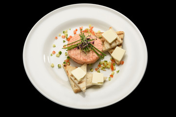 Fresh tartar with salmon, cucumber  on white plate,