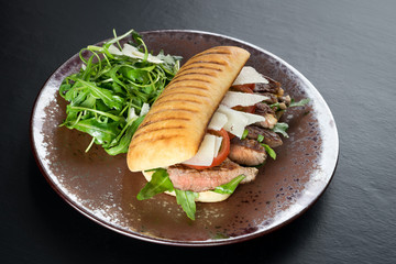 grilled steak medium fresh baked ciabatta sandwich beer
