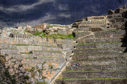 View to impressive inca terraces of Araqama Ayllu with dramatic sky, Ollantaytambo, Sacred Valley, Peru
