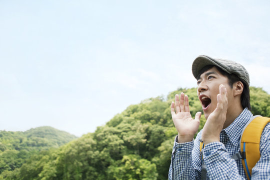 Man shouting at a mountain