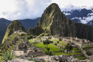 Machu Picchu, ruins in sunlight, clouds in the background, in springtime, Unesco World Heritage site, Sacred Valley, Peru 