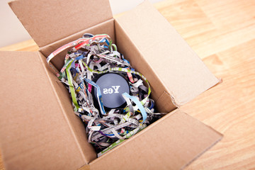 Wooden block with the word Yes wrapped in a box