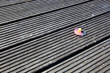 Dropped pacifier on wooden flooring