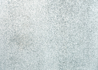 Galvanized steel sheet background in three shades of gray.