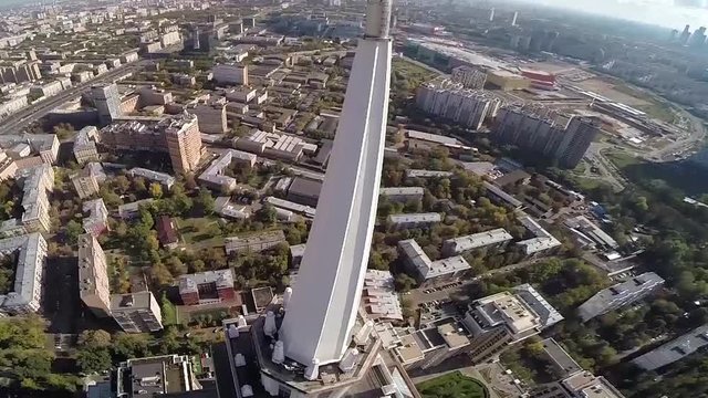 Aerial view of highest Moscow Building Triumph-Palace. Exterior of skyscraper Triumph-Palace against megalopolis at sunny day. House is tallest living building in Europe with high 264,5 meters.