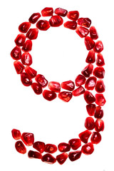 The number nine pomegranate seeds isolated on white background. For the design of education or diet