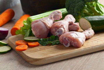 raw vegetables with chicken drumsticks