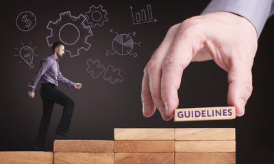 Business, Technology, Internet and network concept. Young businessman shows the word: Guidelines