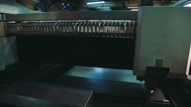 Laser manufacture of steel parts. Industrial robotic laser cutter cuts metal parts with great precision. Automation of process indoors. Automatic work for ironwork. computer cnc