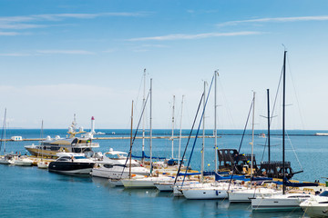 Fototapeta premium Yachts are moored to the pier in the sea port