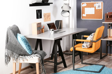 Workplace with a table and chairs in a teenage boy's room