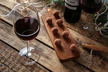 Fotobehang Red wine, chocolate dessert and Christmas decorations on wooden table © Africa Studio
