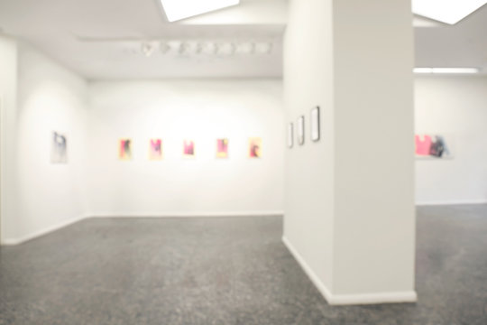Blurred view of empty art gallery with pictures