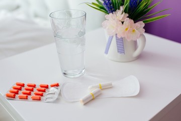 Woman menstruation products on white cabinet