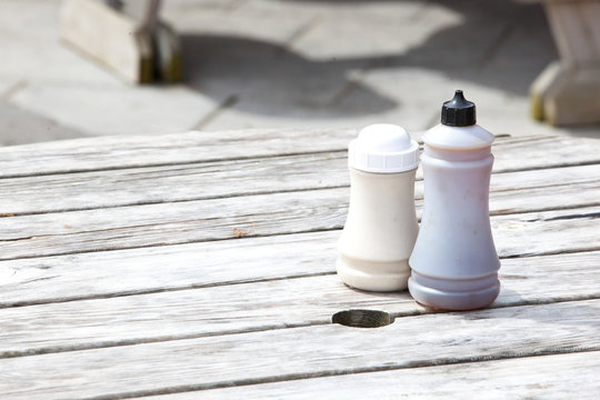 Salt and vinegar bottles on wooden table