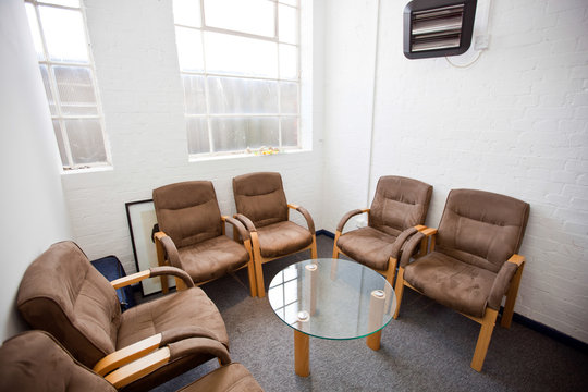 Interior of waiting room with chairs and table in television station