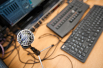 Microphone and computer keyboards on table at television studio