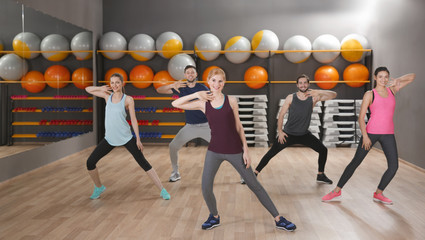 Young sporty people training in gym