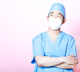 Young  Asian surgeon with arms folded