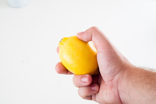 Fresh yellow lemon in hand of man