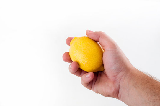 Fresh yellow lemon in hand of man